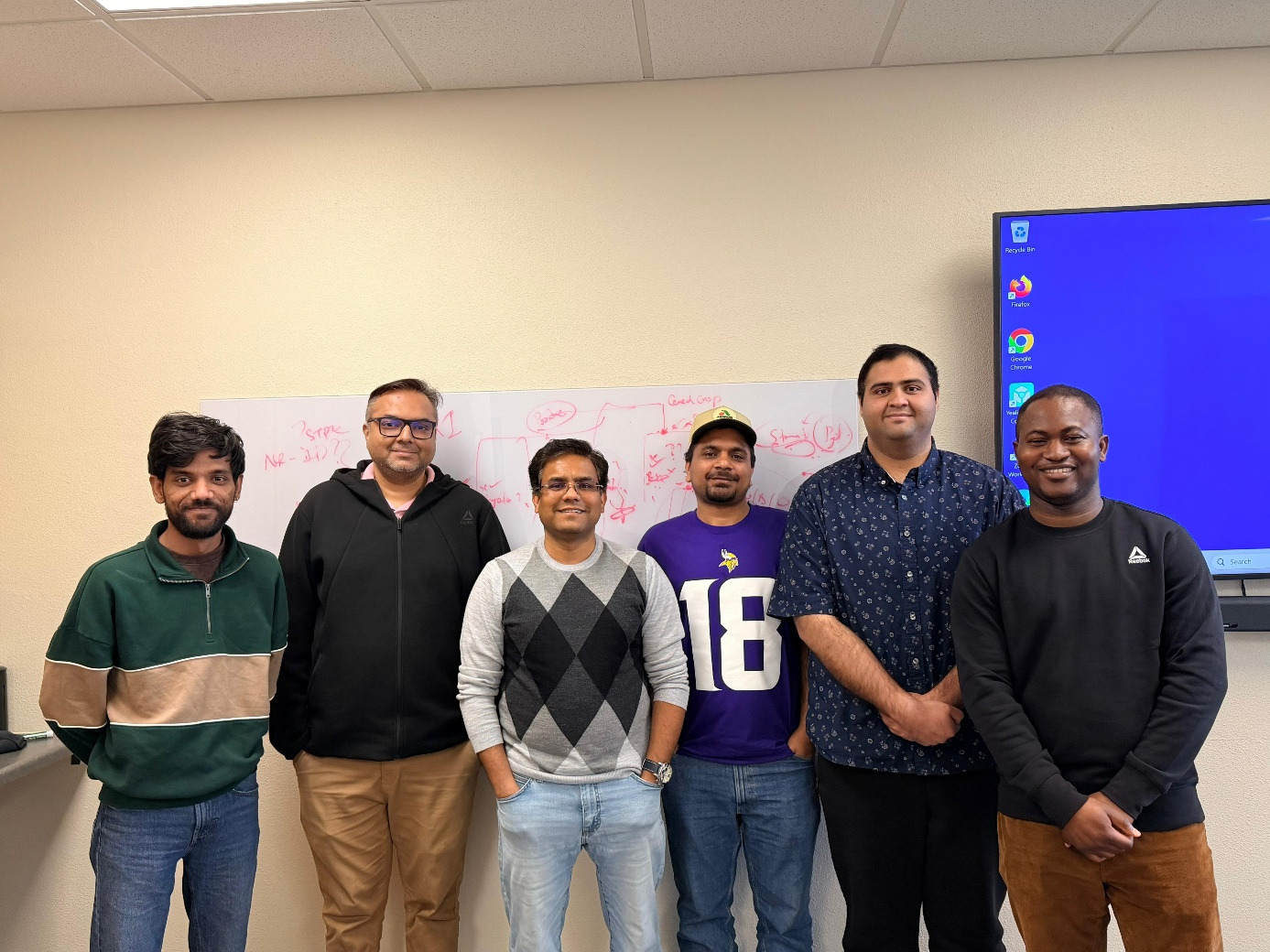 Solanki Lab group together in a meeting room